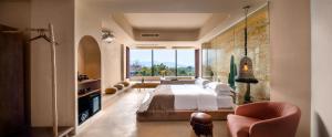 a bedroom with a bed and a large window at Qingyuan Zhilin Hot Spring Bed and Breakfast in Qingyuan
