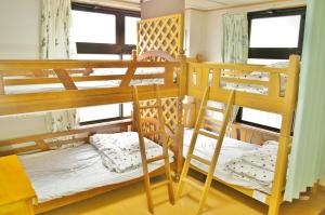 Ένα ή περισσότερα κρεβάτια σε δωμάτιο στο 奥駿河ゲストハウス +21 φωτογραφίες