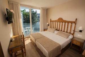 Кровать или кровати в номере Hotel Villa Flamenca