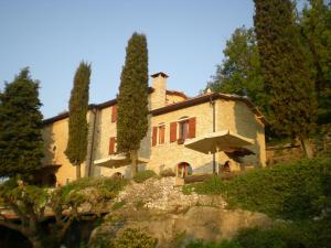 a large stone house with trees in front of it at B&B Le Corone in Cavalo