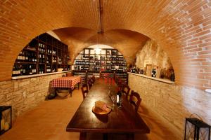 a room with a table and chairs in a wine cellar at B&B Le Corone in Cavalo