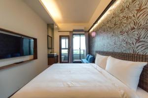 Postel nebo postele na pokoji v ubytování 嬉安平 Si Anping by Hotel Si