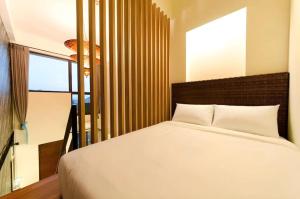 Postel nebo postele na pokoji v ubytování 嬉安平 Si Anping by Hotel Si