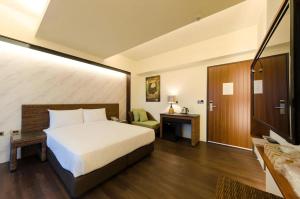 Postel nebo postele na pokoji v ubytování 嬉安平 Si Anping by Hotel Si