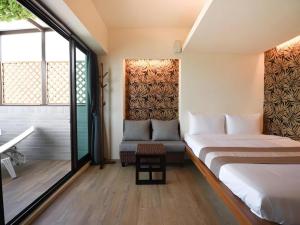 Postel nebo postele na pokoji v ubytování 嬉安平 Si Anping by Hotel Si
