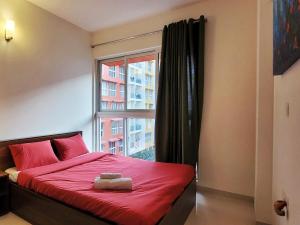 a bedroom with a red bed and a window at No Fixed Address in Marmagao +37 photos