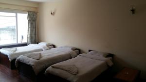 Postel nebo postele na pokoji v ubytování Kathmandu Madhuban Guest House