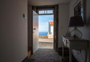 an open door to a room with a view of the ocean at Casa do Simão in Nordeste