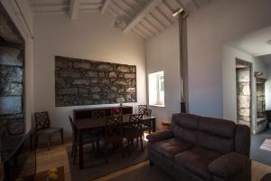 a living room with a couch and a table at Casa do Simão in Nordeste