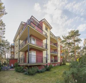 an apartment building with balconies on the side of it at Apartament Dominika in Jurata