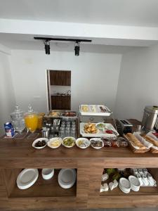 a table with plates of food on it at Villa Forest Ohrid in Peštani