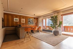 a kitchen and dining room with a table and chairs at Gran Tubla Apartments in Ortisei