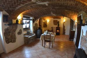 a dining room with a table and a kitchen in a building at B&B Ca' dla Nona in Brusasco