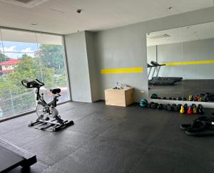 a room with a gym with a bike and a mirror at Northwoods Place Condominium Unit1026 in Mandaue City