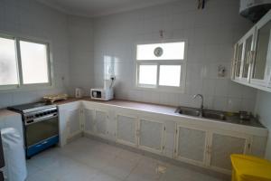a kitchen with a sink and a stove at Luxury Villa Beach Front in Salalah