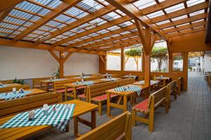 an empty restaurant with wooden tables and benches at Apetlon`er Familie Böhm in Apetlon