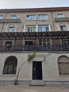 a building with a balcony on top of it at Home in Borjomi in Borjomi
