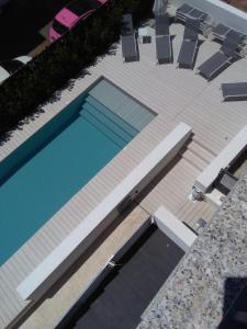 an overhead view of a swimming pool on a deck at Hotel Nettuno in Cala Gonone