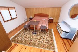 a bedroom with a bed and a table and a couch at Apartments Peteh in Rovinj