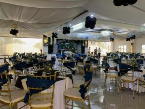 a banquet hall with blue and white tables and chairs at La Traviesa Hotel Resort in General Trias