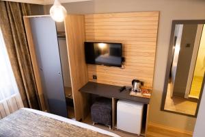 a hotel room with a television on a wall at Çağ Otel in Erzurum