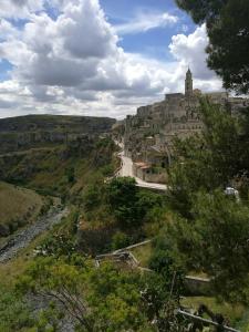 a view of a town on a hill with a road at Frammenti in Matera