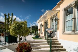 a person taking a picture of a house at Hotel Nova Sintra - Adults only in Sintra
