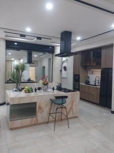 a large kitchen with a island in a room at De Santos in Mama