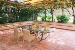 a glass table and chairs on a patio at Villa Cortile Mastro Francesco Ravello centre Amalfi Coast in Ravello