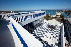 a balcony with a checkered floor and a view of the ocean at Galapagos Family Vacation 3 bedrooms 7 guests Centrally located and ocean view in Puerto Ayora