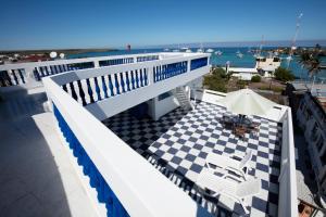 a balcony with a checkered floor and a view of the ocean at Casa Marina Galapagos in Puerto Ayora