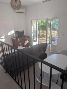 a living room with a couch and a table at charmant t2 in Petreto-Bicchisano