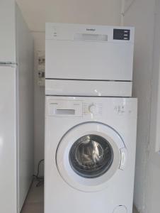a white washer and dryer in a room at charmant t2 in Petreto-Bicchisano