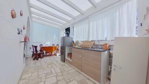 a kitchen with a refrigerator and a table at i trulli di Holly in Selva di Fasano