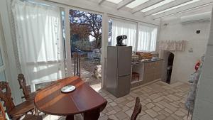 a kitchen with a table and a table and a dog at i trulli di Holly in Selva di Fasano
