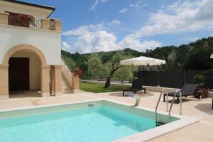 a swimming pool in a yard with a house at Residence Stella Del Gran Sasso in Colledara