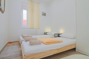 a bedroom with two beds with towels on them at Sveti Marin Rab in Rab
