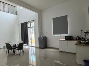 a kitchen with a table and a tv in a room at Padang Serai Wangi Homestay 91 in Padang Serai +44 photos