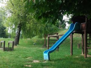 a blue slide in a park under a tree at Likaskalács in Regöly