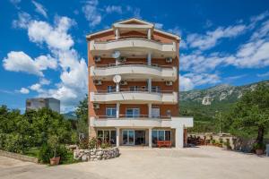 a tall building in front of a mountain at Villa Ivanovic in Budva