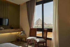 a hotel room with a view of the pyramids at Pyramids Secret Hotel in Cairo