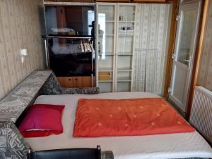 a bedroom with a bed with a red blanket at City Center Rooms in Budapest