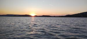 a sunset over a large body of water at Balatoni Fészek in Badacsonytomaj