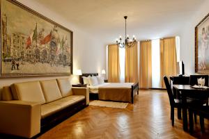 a living room with a couch and a bed at Da Vinci in Braşov +43 photos