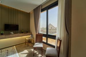 a living room with a large window with a view at Pyramids Secret Hotel in Cairo