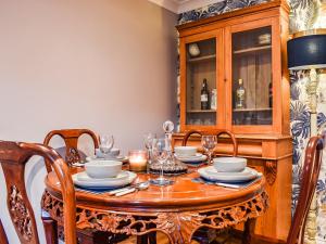 a dining room with a wooden table and chairs at Coopers Townhouse - Cottage in Worle