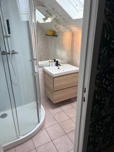 a bathroom with a sink and a shower at Beach Bungalow Green in Middelkerke +30 photos