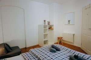 a small room with a bed and a chair at Casa Santini in Jáchymov