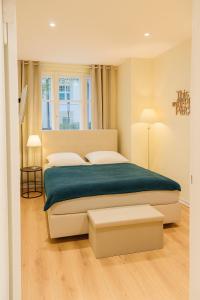 a bedroom with a large bed with a green blanket at glorious cloud apartment in Berlin