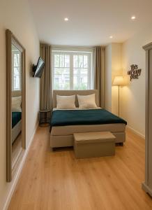 a bedroom with a bed and a large window at glorious cloud apartment in Berlin